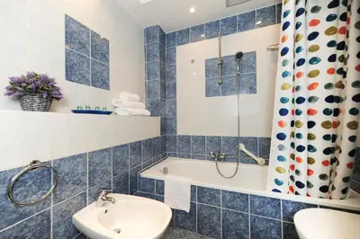 a bathroom with a tub and a sink at Suite Halevy 5 stars Holiday House in Nice