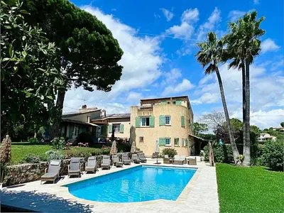 a house with a swimming pool in front of a house at Villa Antoline in Cagnes-sur-Mer