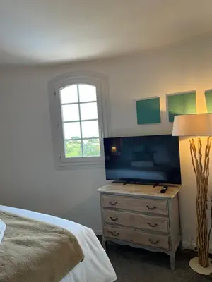 a bedroom with a bed and a television on a dresser at Villa Antoline in Cagnes-sur-Mer