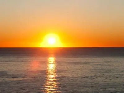 a sunset over the ocean with the sun setting at France Nice Promenade Des Anglais 80m² Piano in Nice