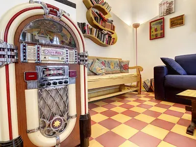 a living room with a machine in the middle of a room at Nestor&Jeeves - SIXTIES - Central - Very close sea - Retro in Nice