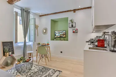 a kitchen and living room with a table at MY CASA - LA CIVETTE - Place Garibaldi in Nice