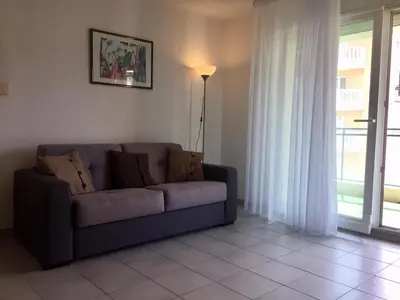 a living room with a couch and a window at Palais des Domes Gloria in Nice