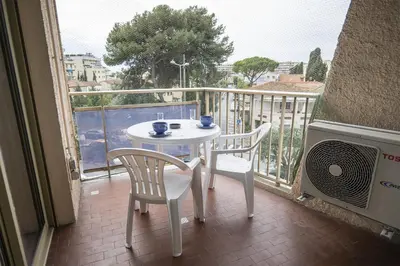 a white table and two chairs on a balcony at Maresol in Cagnes-sur-Mer