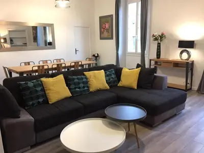 a living room with a black couch and a table at Port de Nice in Nice