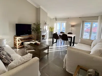 a living room with white couches and a table at Promenade sur les toits in Nice