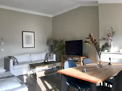 a living room with a white couch and a table at Promenade sur les toits in Nice
