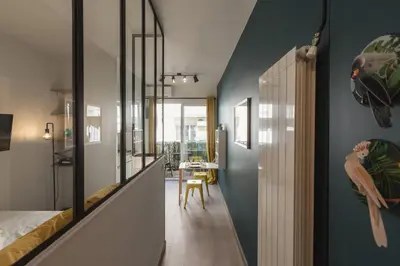 a bedroom with a bed and a hallway with a table at Nicelidays - Le Berlioz - city central - 7min from beaches in Nice