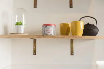 a wooden shelf with three mugs on it at Nicelidays - Le Berlioz - city central - 7min from beaches in Nice