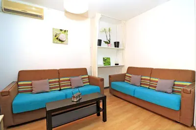 a living room with two couches and a coffee table at SOPHIES HOMES APARTEMENT BEACH and PROMENADE DES ANGLAIS in Nice