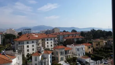a city with houses and mountains in the background at SOPHIES HOMES APARTEMENT BEACH and PROMENADE DES ANGLAIS in Nice