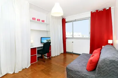 a living room with a couch and a desk with a computer at SOPHIES HOMES APARTEMENT BEACH and PROMENADE DES ANGLAIS in Nice