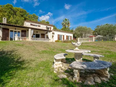 a stone table and bench in front of a house at Holiday Home La Mesnière by Interhome in Gattières
