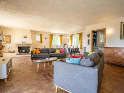 a living room with two couches and a table at Holiday Home La Mesnière by Interhome in Gattières