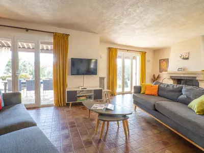 a living room with a couch and a tv at Holiday Home La Mesnière by Interhome in Gattières