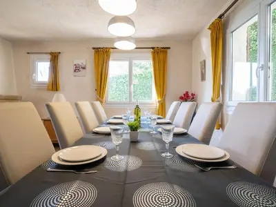 a dining room with a long table and chairs at Holiday Home La Mesnière by Interhome in Gattières