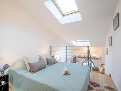 a bedroom with a blue bed in a room with a ceiling at Apartment Wilson by Interhome in Nice