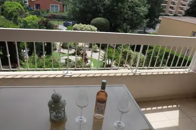 a bottle of wine sitting on a table on a balcony at Renoir Appartement in Cagnes-sur-Mer