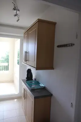 a kitchen with wooden cabinets and a counter top at Renoir Appartement in Cagnes-sur-Mer