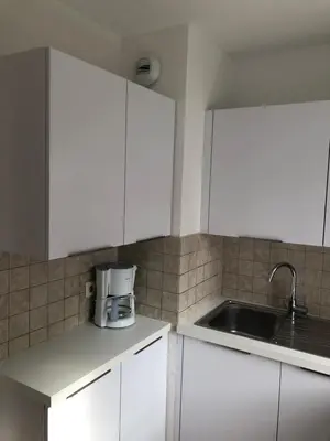 a kitchen with white cabinets and a sink at Palais des domes in Nice