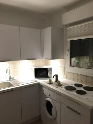 a kitchen with a washing machine and a microwave at Palais des domes in Nice