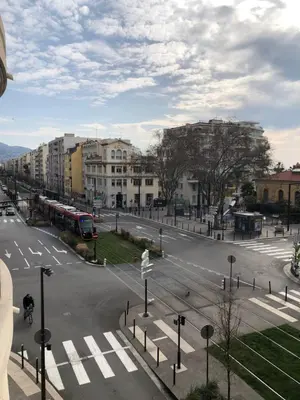 an empty city street with a bus on the road at Palais des domes in Nice