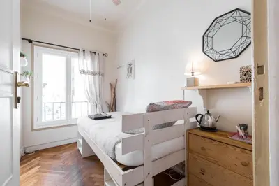 a bedroom with a bed with a dresser and a window at 6 bedrooms seaview house, Old Town in Nice