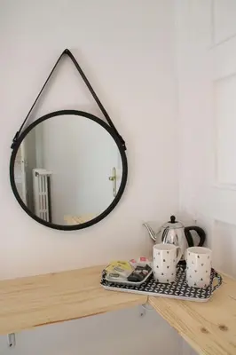 a mirror sitting on top of a wooden table at 6 bedrooms seaview house, Old Town in Nice