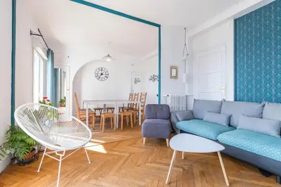 a living room with a blue couch and a table at 6 bedrooms seaview house, Old Town in Nice