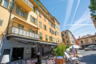 a building with a balcony on the side of a street at Place Du Pin in Nice