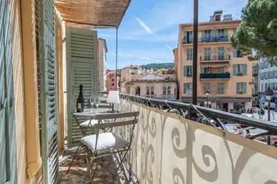 a balcony with a table and chairs on a balcony at Place Du Pin in Nice