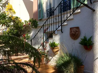 a building with a staircase and plants on it at Hotel Villa Rose in Nice