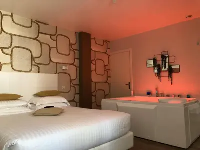 a bedroom with a white bed and a sink at Hotel Villa Rose in Nice