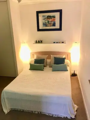 a bedroom with a large white bed with two pillows at L'Alivu in Nice