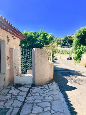 a fence on the side of a road next to a house at L'Alivu in Nice
