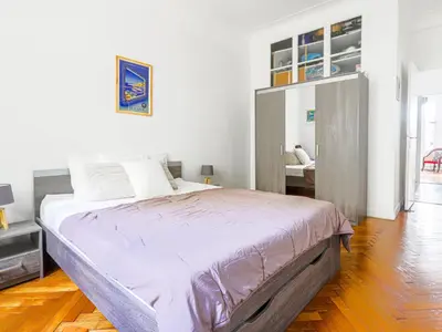 a white bedroom with a large bed in it at Apartment Le Rossi by Interhome in Nice