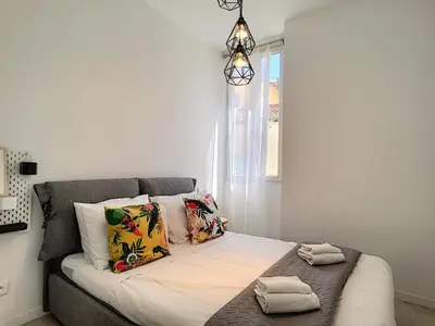 a bedroom with a bed with pillows and a window at Nestor&Jeeves - HOUSE OF CARDS - Central - Very close sea in Nice