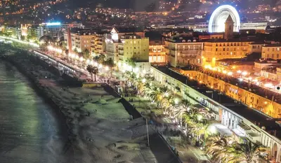 a city at night with a river and buildings at Nice Seaview Free Parking 4.Pers in Nice