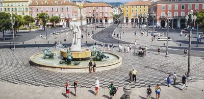 a group of people walking around a fountain in a city at Nice Seaview Free Parking 4.Pers in Nice