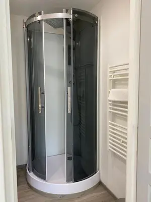 a shower in a bathroom with a glass door at Intérieurs-Cour in Nice