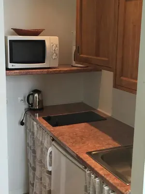 a kitchen with a microwave and a sink at Studios Floreal in Nice