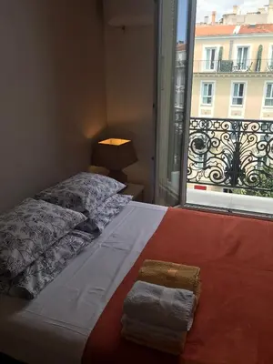 a bedroom with a bed and a window with a view at Studios Floreal in Nice