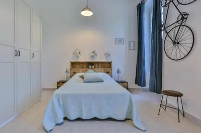 a bedroom with a bed and a bike on the wall at MY CASA - GARIB - Place Garibaldi - 4 bedrooms - Balcony in Nice