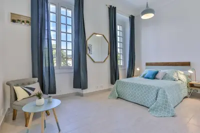 a bedroom with a bed and a mirror and a chair at MY CASA - GARIB - Place Garibaldi - 4 bedrooms - Balcony in Nice