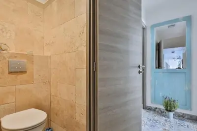 a bathroom with a toilet and a glass door at MY CASA - GARIB - Place Garibaldi - 4 bedrooms - Balcony in Nice