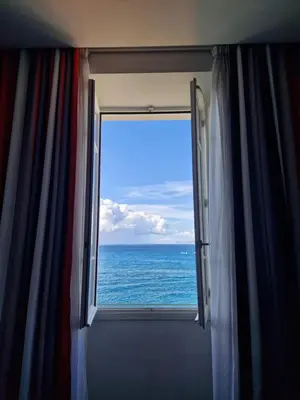 a hotel room with a view of the ocean at Hotel Le Saint Paul in Nice