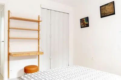 a bedroom with a bed and a book shelf at Place du Pin in Nice