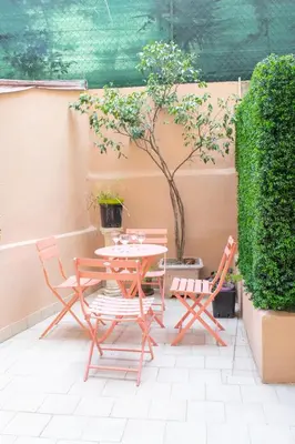 a patio with a table and two chairs at Place du Pin in Nice