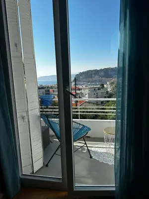 an open door to a balcony with a blue chair at Villa Iris in Nice