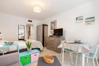 a living room with a bed and a table and chairs at Studio Massenet Five stars holiday house in Nice